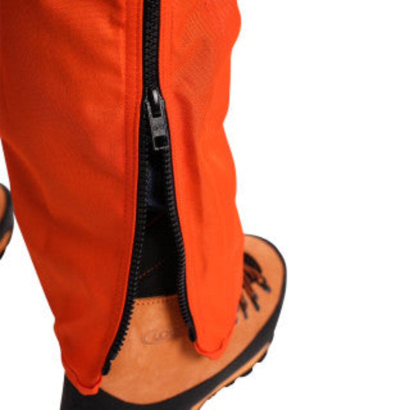 Close-up of orange pants with a black zipper on a white background