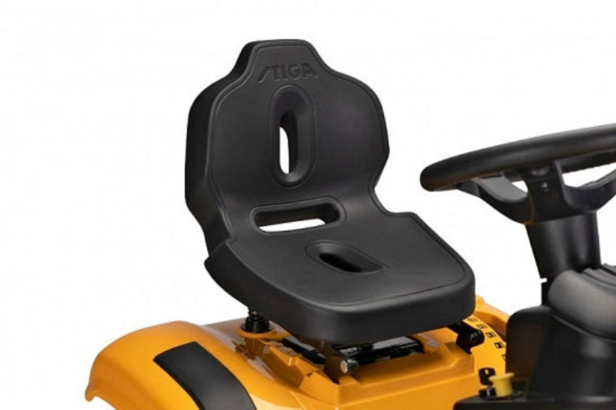 Close-up of a black seat and steering wheel on a yellow Stiga Combi 372 ride-on lawn mower with 'Stiga' branding.