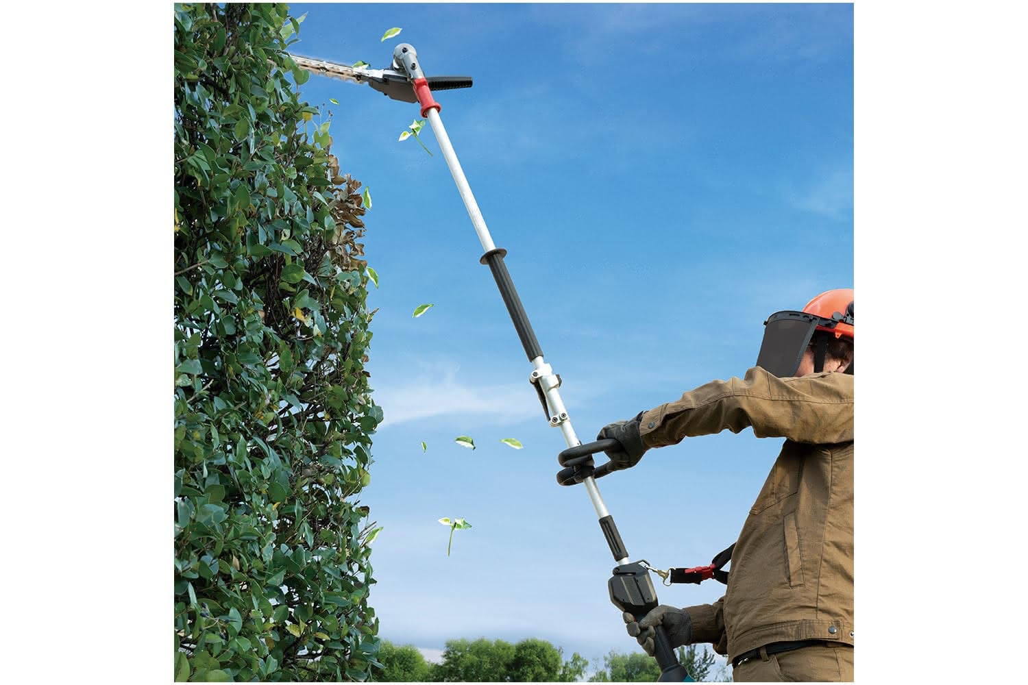 Images shows a person using a Makita muti-tool with hedgetrimmer attachment in use cutting a hedge