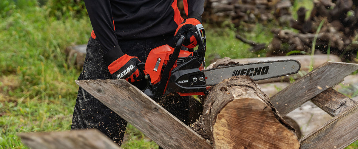 Echo chainsaw in use cutting a log