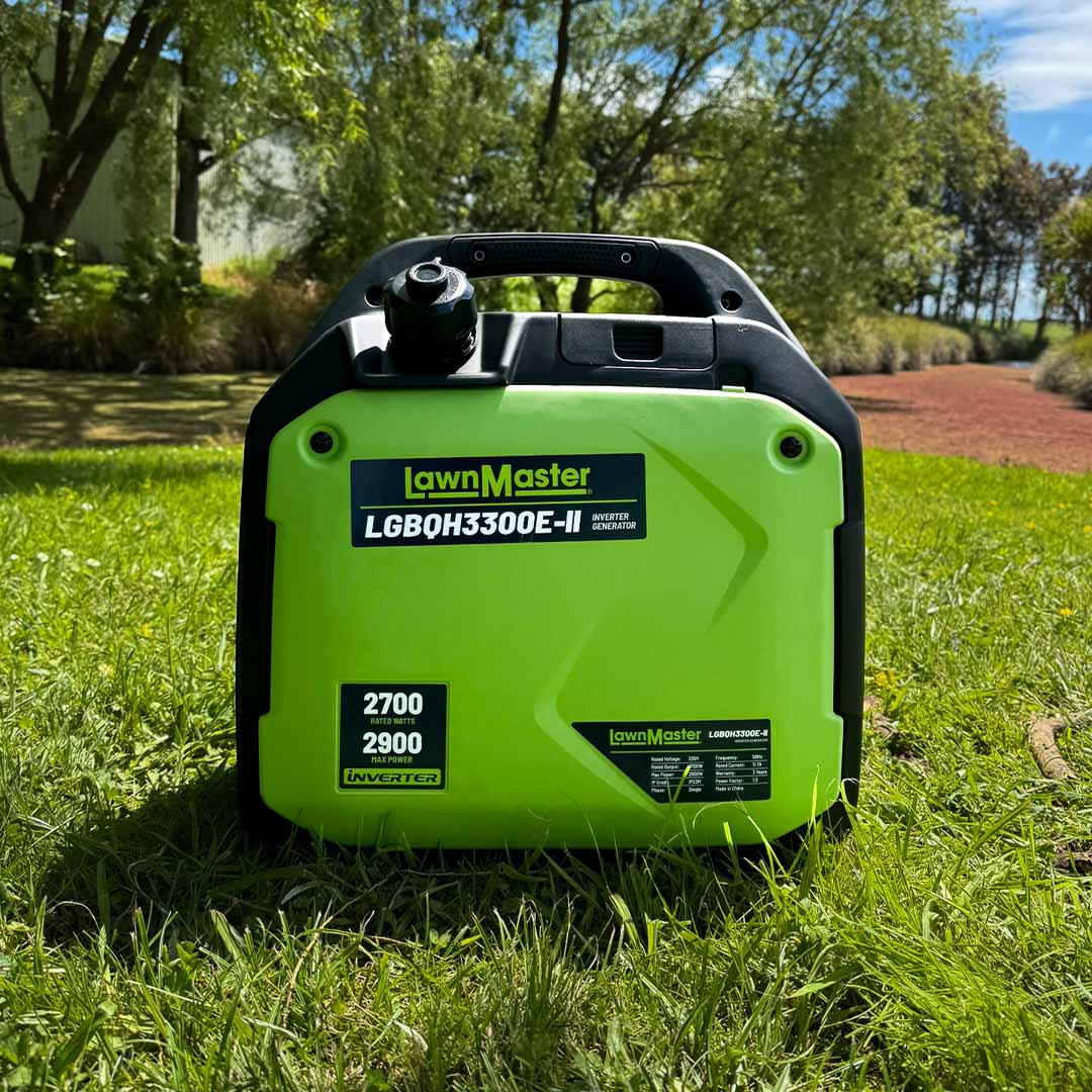 Green and black LawnMaster generator on grass with trees in the background